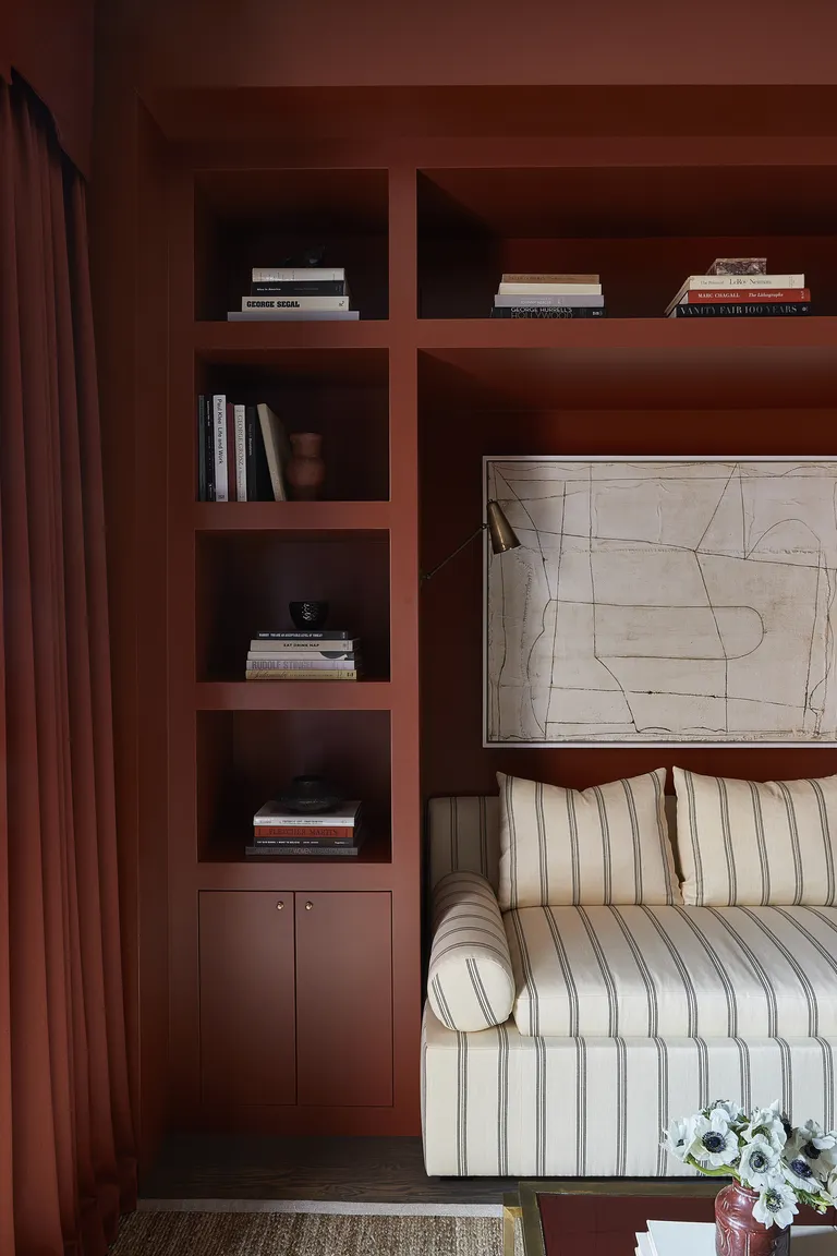 A reading corner with red painted walls