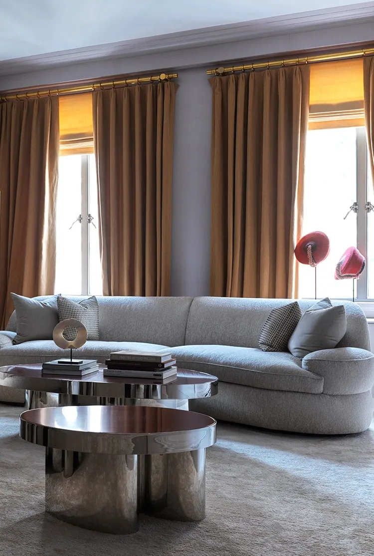 A light grey sofa and yellow curtains