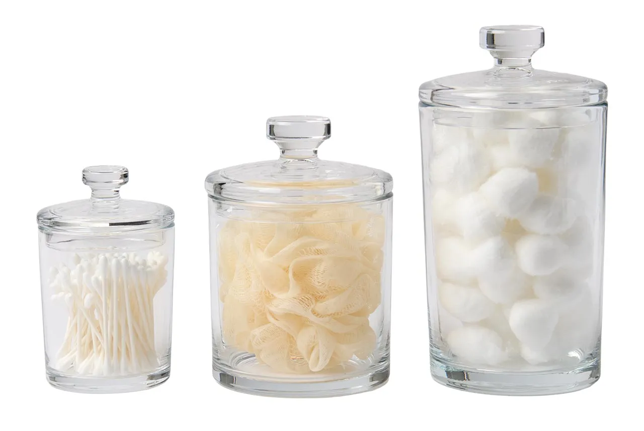 Three apothecary glass jars with lids