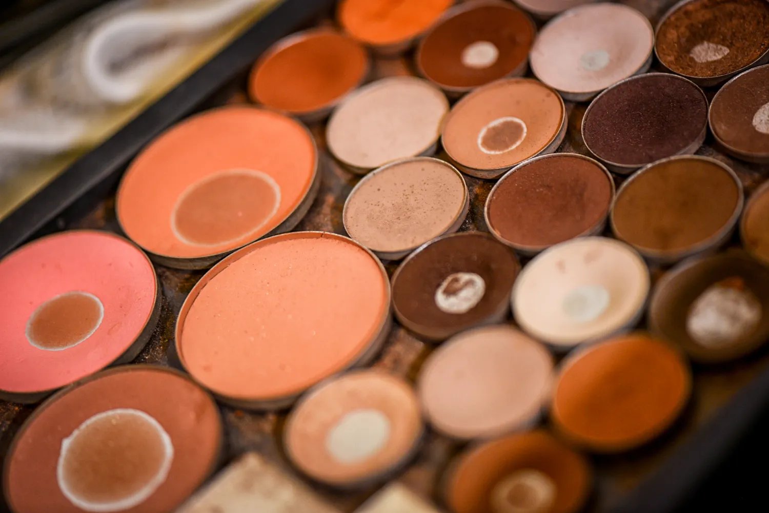 Several nude-colored makeup palettes, ranging in hue from pink to brown to ebony.