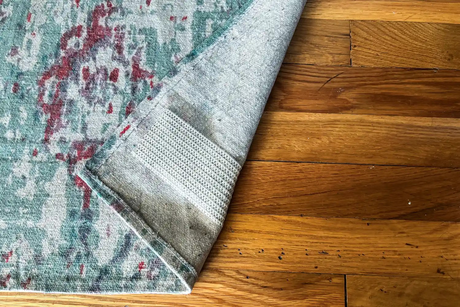 The Nance Great Tape Rug Gripper Anti-Slip Rug Tape attached to the underside of a rug